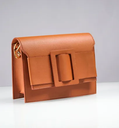 Leather handbag on a white surface